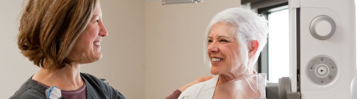 Mammographer Holly Blue and a patient in front of the new 3D mammography equipment