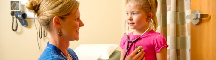 Carrie Kingsley, ARNP, checks the heartbeat of a pediatric patient.