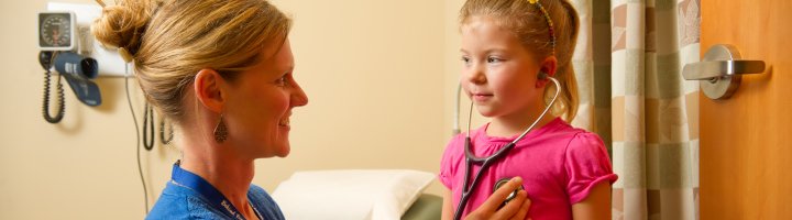 Carrie Kingsley, ARNP, checks the heartbeat of a pediatric patient.